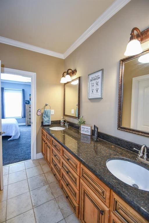 bathroom with crown molding, tile patterned floors, a sink, and double vanity