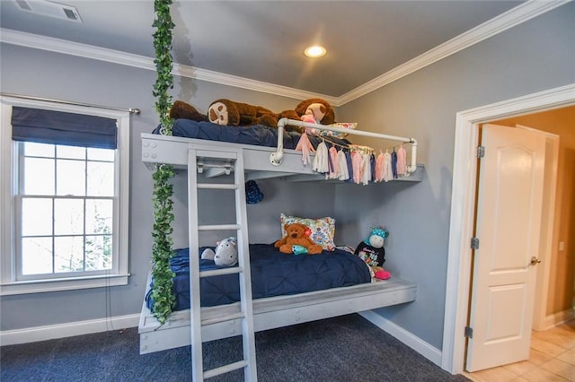 carpeted bedroom featuring baseboards, visible vents, and crown molding