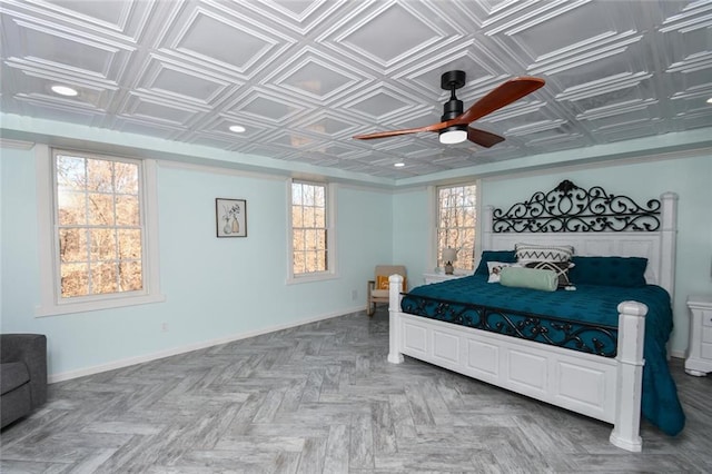 bedroom featuring an ornate ceiling, baseboards, and a ceiling fan