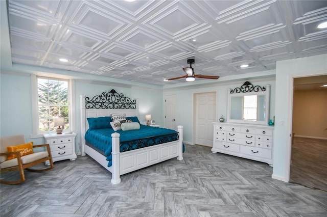 bedroom with an ornate ceiling, baseboards, and a ceiling fan