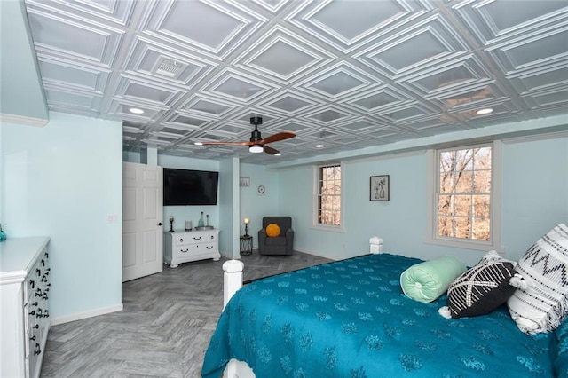 bedroom featuring ceiling fan, visible vents, an ornate ceiling, and baseboards