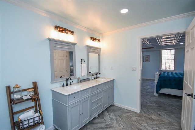 full bathroom featuring crown molding, double vanity, a sink, and baseboards