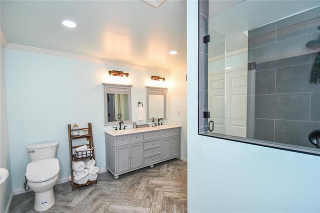 bathroom featuring toilet, a stall shower, baseboards, and a sink