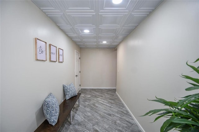 hallway with recessed lighting, wood finished floors, an ornate ceiling, and baseboards