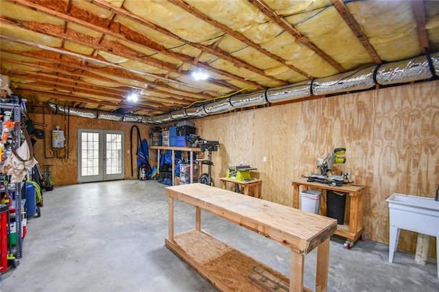 basement featuring french doors and a workshop area