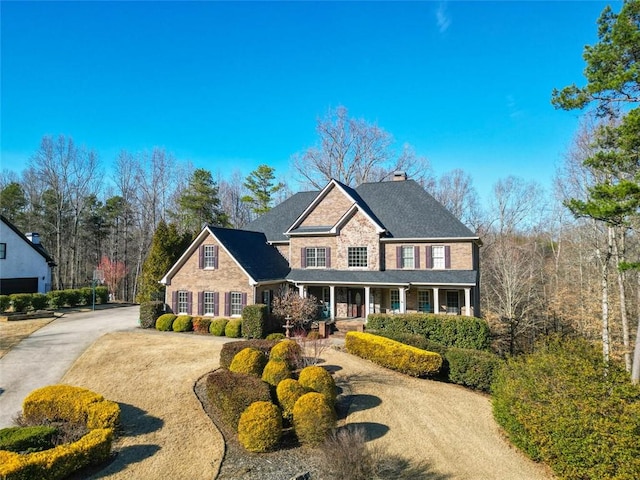 view of front of house with driveway and a chimney