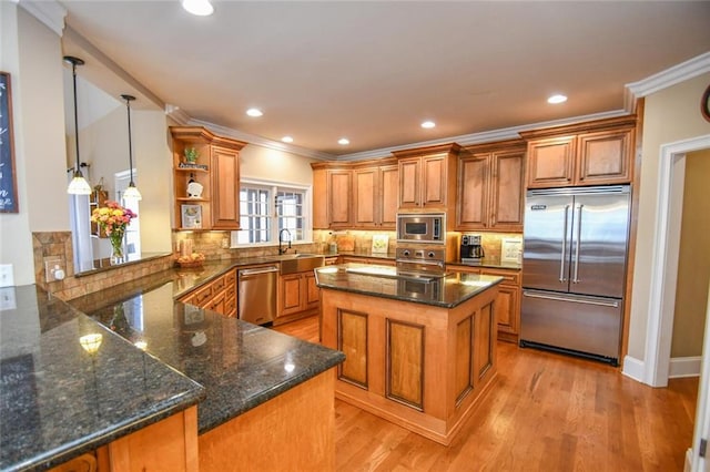 kitchen with tasteful backsplash, dark stone counters, brown cabinetry, built in appliances, and open shelves