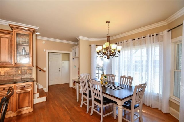 dining area featuring a wealth of natural light, ornamental molding, dark wood finished floors, and a notable chandelier