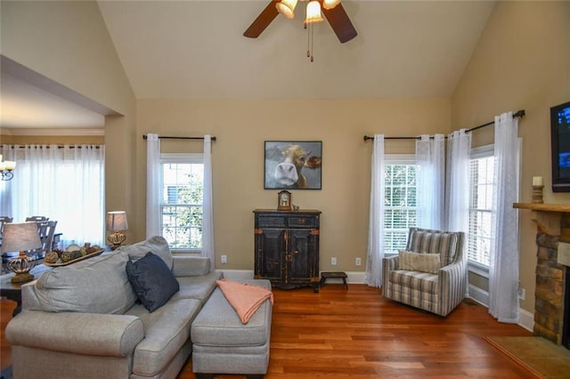 living room with lofted ceiling, plenty of natural light, a fireplace, and wood finished floors