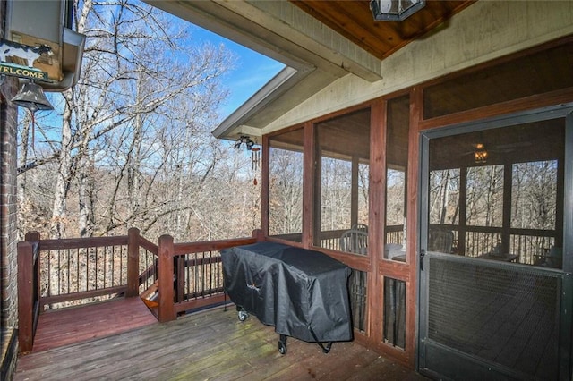 deck with a sunroom and a grill