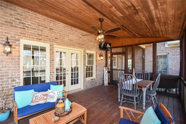 wooden deck with french doors and a ceiling fan