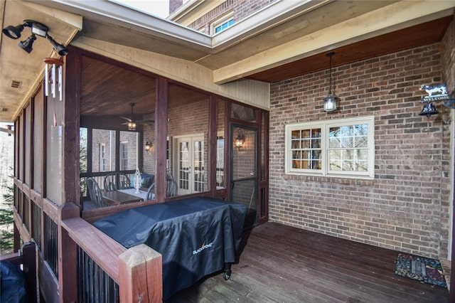 deck with visible vents and a sunroom