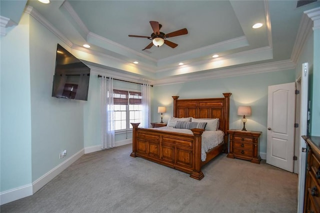 bedroom featuring light carpet, baseboards, ornamental molding, a tray ceiling, and recessed lighting