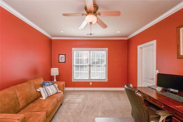 carpeted home office with a ceiling fan, visible vents, baseboards, and crown molding