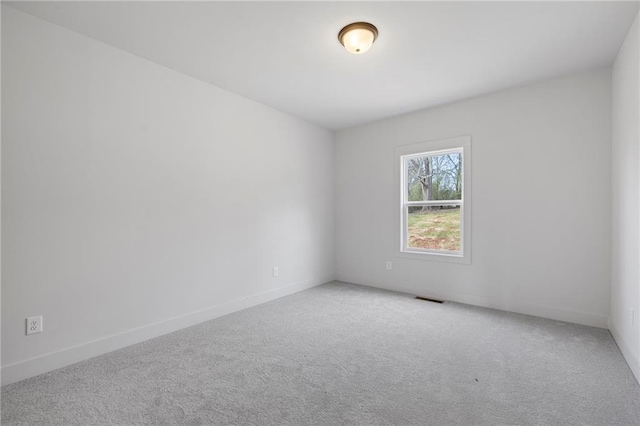 carpeted empty room with baseboards