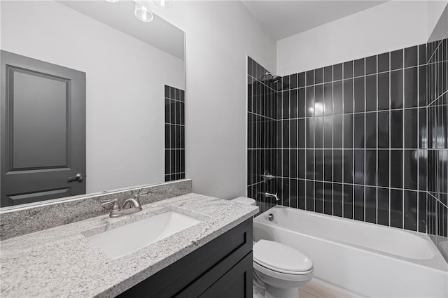 bathroom with toilet, washtub / shower combination, and vanity