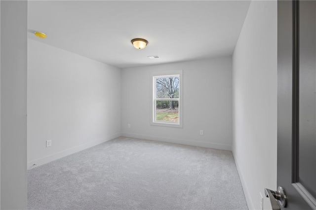carpeted empty room with baseboards and a smoke detector