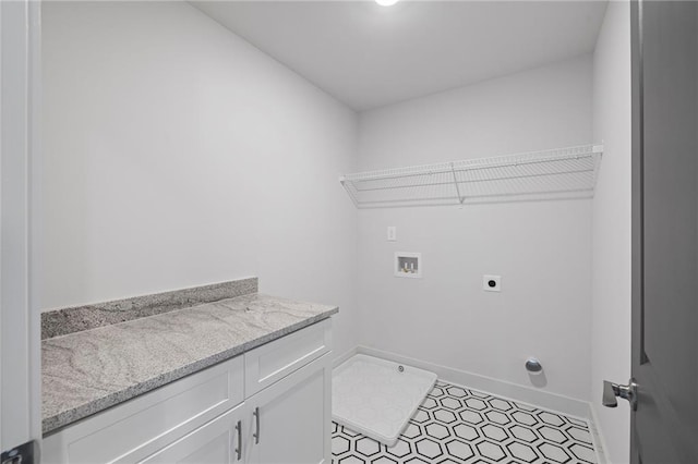 washroom with hookup for a washing machine, hookup for an electric dryer, baseboards, and cabinet space
