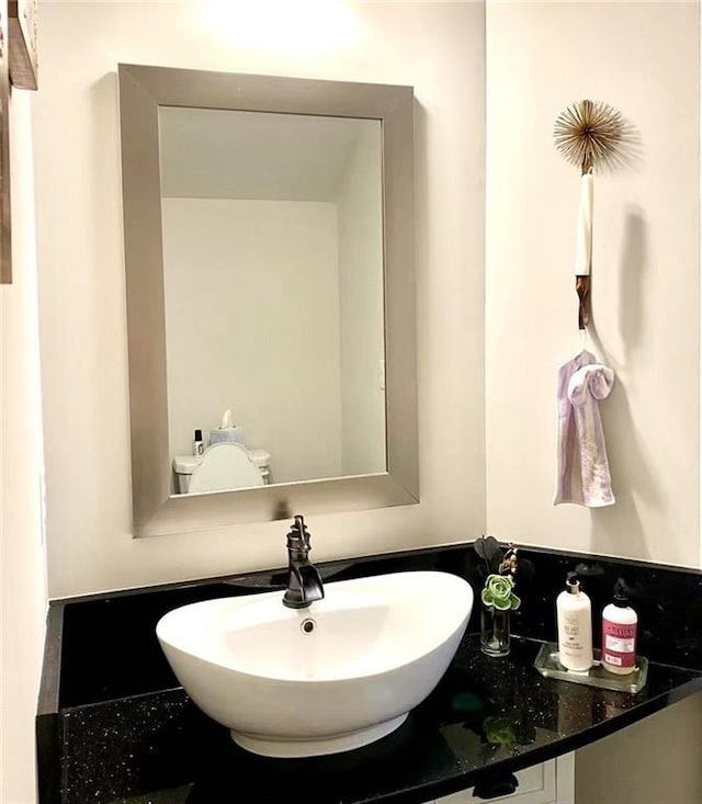 bathroom featuring vanity and toilet