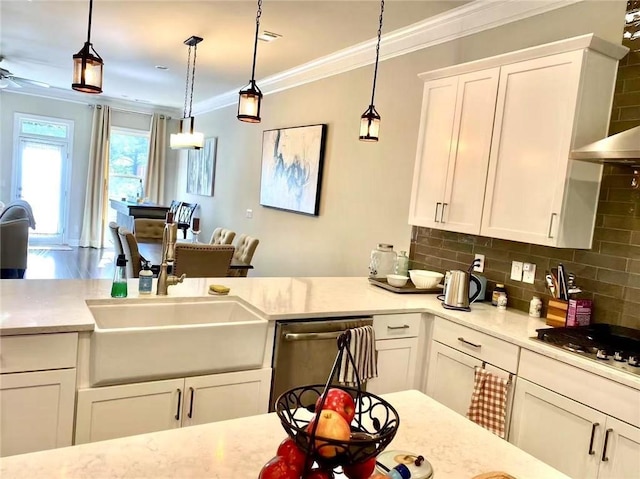 kitchen featuring white cabinetry, sink, hanging light fixtures, and dishwasher