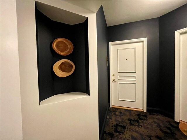 199 14th St NE Unit 710, Atlanta, GA 30309 - hall featuring baseboards and dark carpet