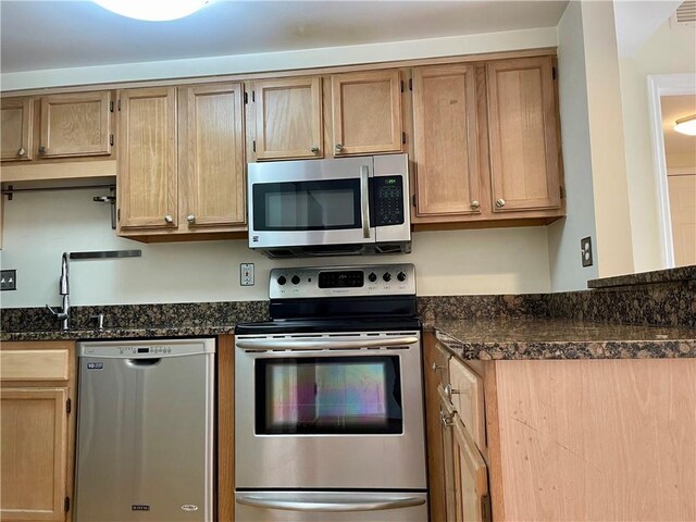 199 14th St NE Unit 710, Atlanta, GA 30309 - kitchen featuring appliances with stainless steel finishes and dark stone countertops
