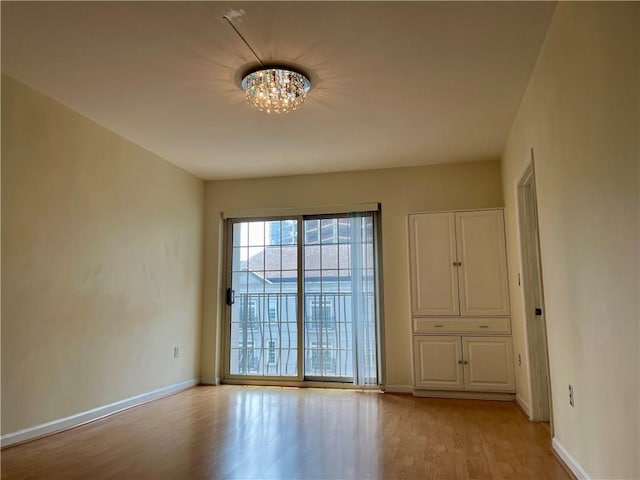 199 14th St NE Unit 710, Atlanta, GA 30309 - unfurnished room with light wood-type flooring and a chandelier