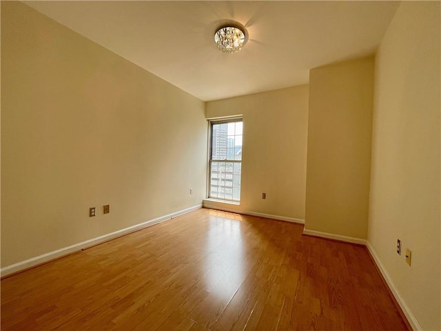 199 14th St NE Unit 710, Atlanta, GA 30309 - empty room with wood finished floors and a chandelier