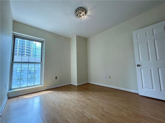 199 14th St NE Unit 710, Atlanta, GA 30309 - spare room featuring wood finished floors and baseboards