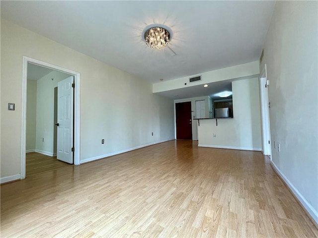 199 14th St NE Unit 710, Atlanta, GA 30309 - unfurnished living room featuring a chandelier and light wood finished floors