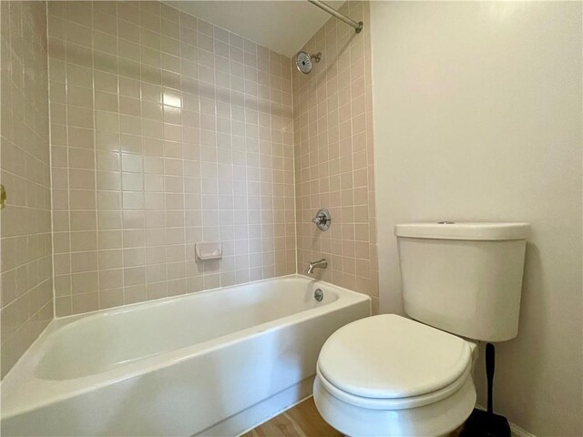 199 14th St NE Unit 710, Atlanta, GA 30309 - bathroom featuring tub / shower combination and wood finished floors
