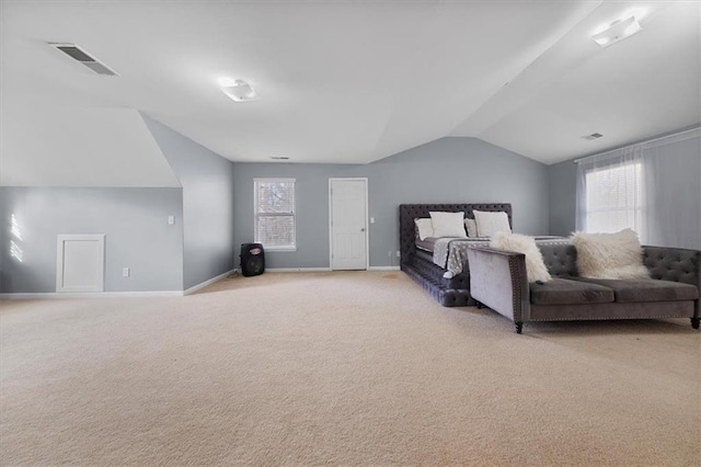 bedroom featuring light carpet, visible vents, baseboards, and lofted ceiling