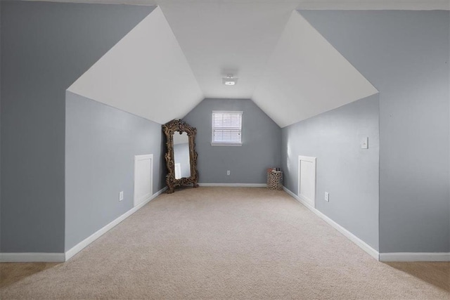 bonus room with baseboards, lofted ceiling, and carpet flooring