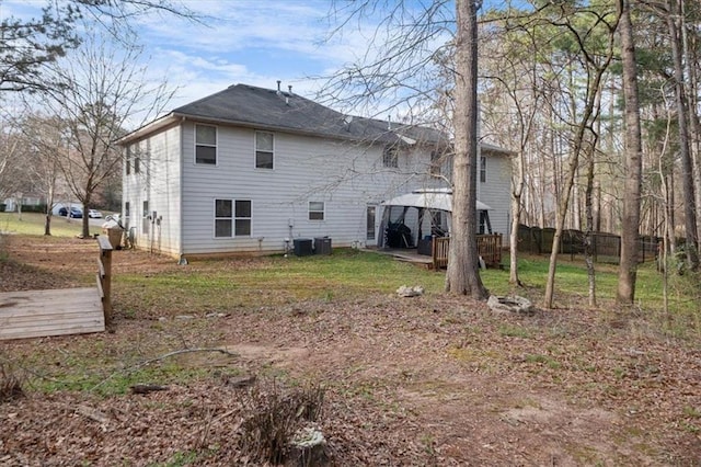 rear view of house featuring a gazebo, cooling unit, a wooden deck, and fence