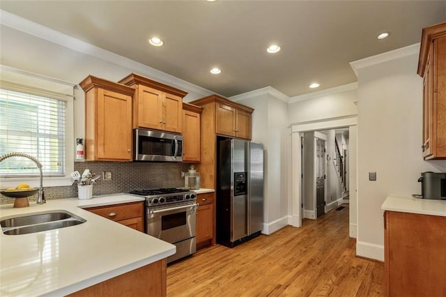 891 Paoli Ave SE, Atlanta, GA 30316 - kitchen featuring appliances with stainless steel finishes, a sink, ornamental molding, tasteful backsplash, and light countertops