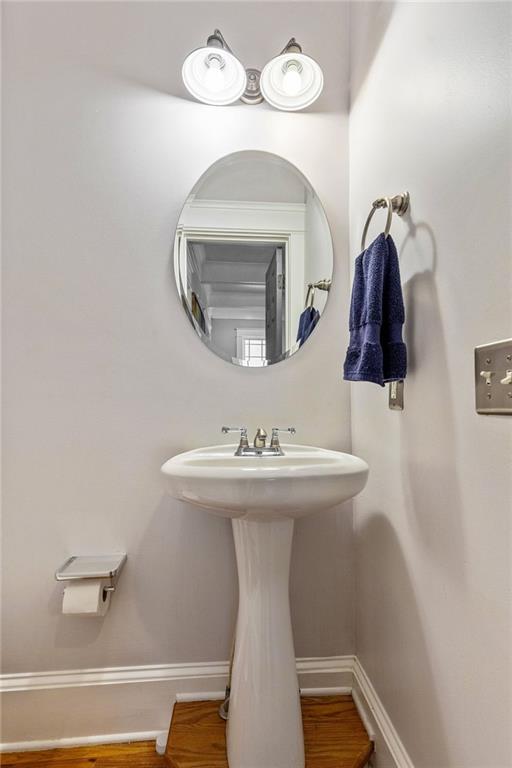 891 Paoli Ave SE, Atlanta, GA 30316 - bathroom featuring baseboards, wood finished floors, and a sink