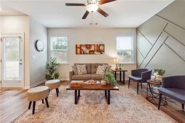 living area featuring ceiling fan, a healthy amount of sunlight, and wood-type flooring