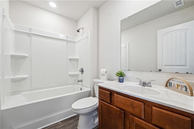 full bathroom featuring hardwood / wood-style flooring, vanity, toilet, and washtub / shower combination