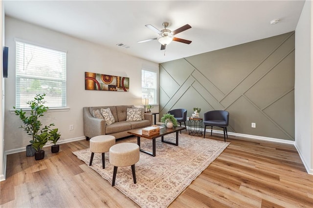 living room featuring ceiling fan and light hardwood / wood-style flooring