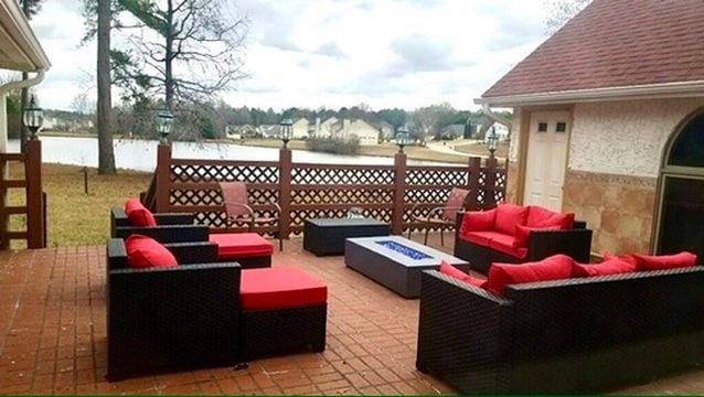 view of patio / terrace featuring an outdoor living space with a fire pit and a water view