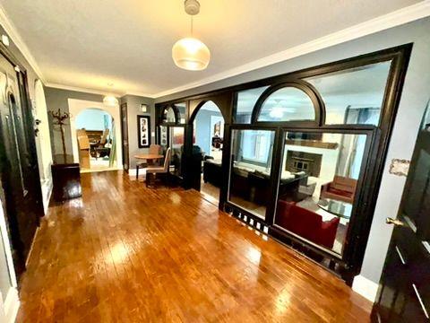 interior space with hardwood / wood-style flooring and ornamental molding