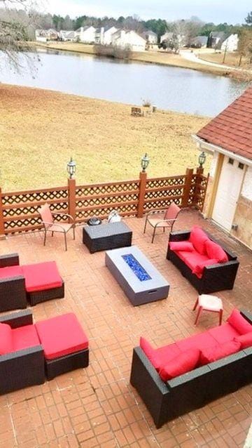 view of patio / terrace with a water view and an outdoor living space with a fire pit