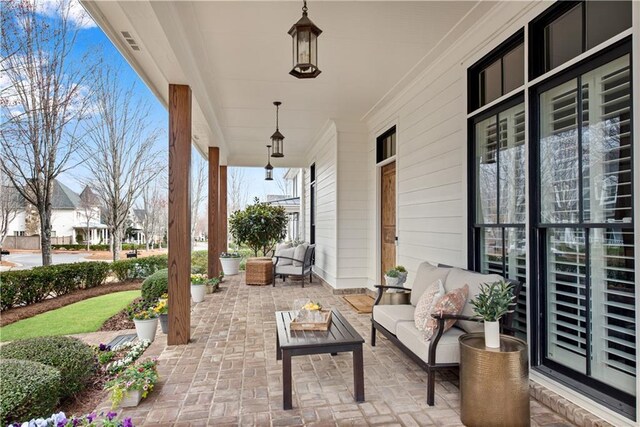 view of patio featuring covered porch and an outdoor hangout area