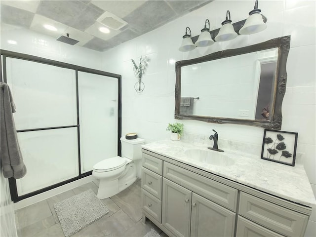 bathroom featuring vanity, tile walls, toilet, and an enclosed shower