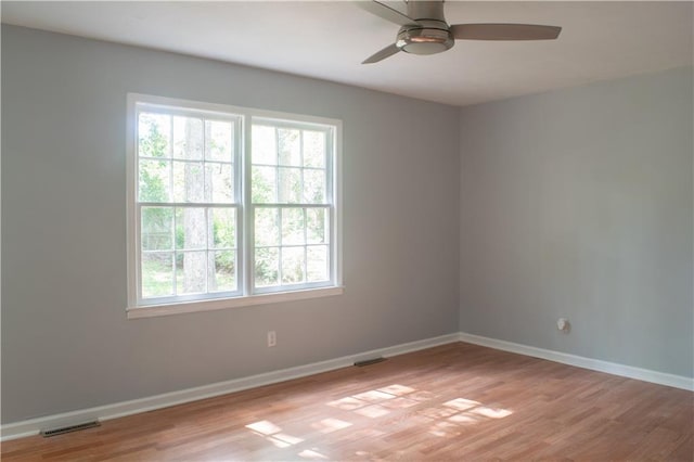 unfurnished room with ceiling fan and light wood-type flooring