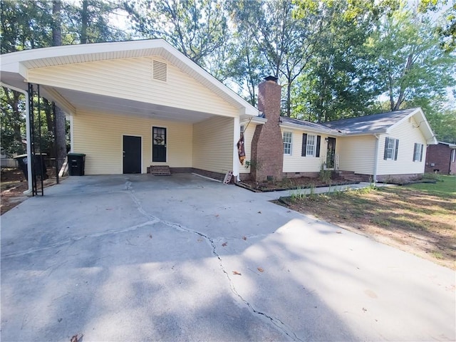 single story home featuring a carport