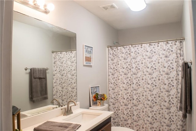 bathroom with vanity, toilet, and a shower with shower curtain