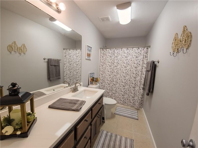 bathroom with vanity, tile patterned flooring, toilet, and walk in shower