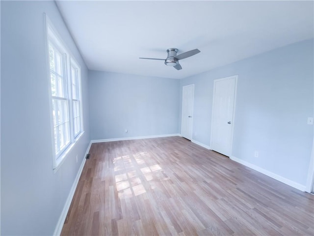 spare room featuring light hardwood / wood-style flooring and ceiling fan