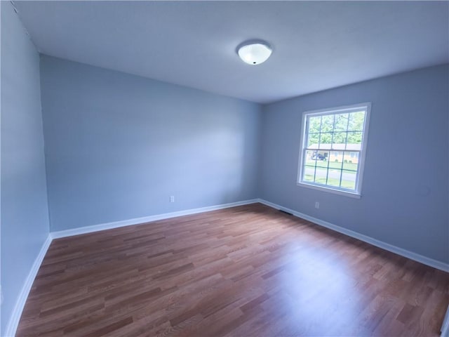 empty room with dark hardwood / wood-style floors